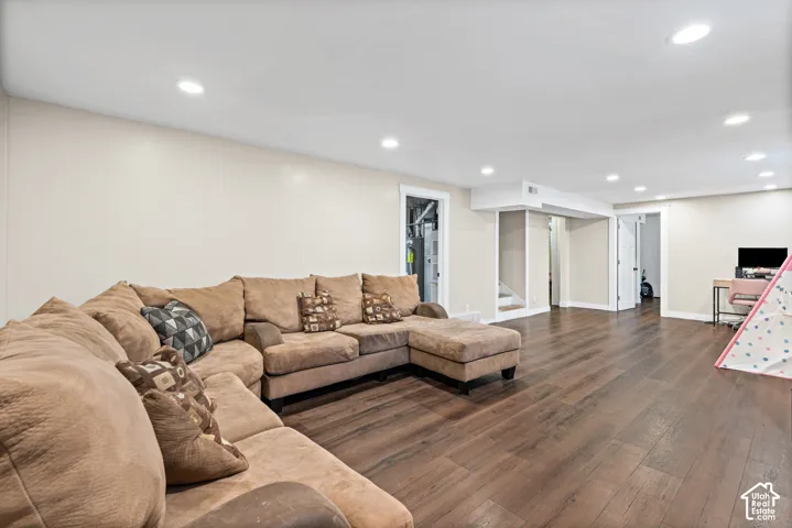 Spacious lower-level area featuring wood-finish flooring, recessed lighting, neutral wall tones, and white trim