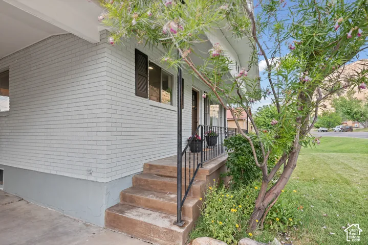 Brick exterior with a covered entryway and concrete steps