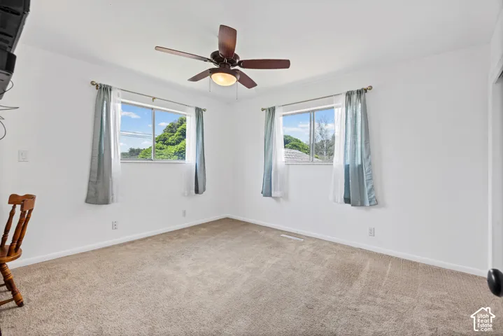 Neutral-toned carpeting and white walls create a versatile interior