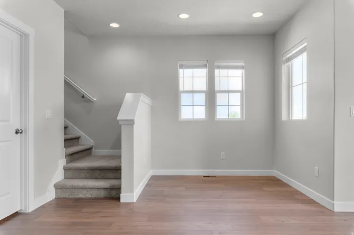 Wood-finish flooring throughout the main area and carpeted stairs