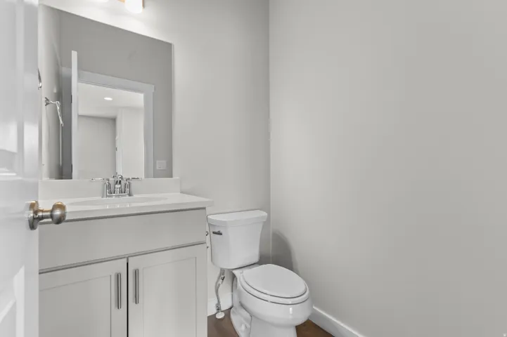 Bathroom featuring a white vanity with a single sink, chrome faucet, and integrated countertop