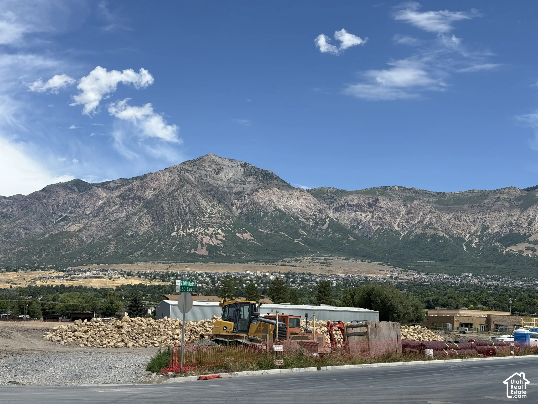 Expansive mountain backdrop with distant residential areas