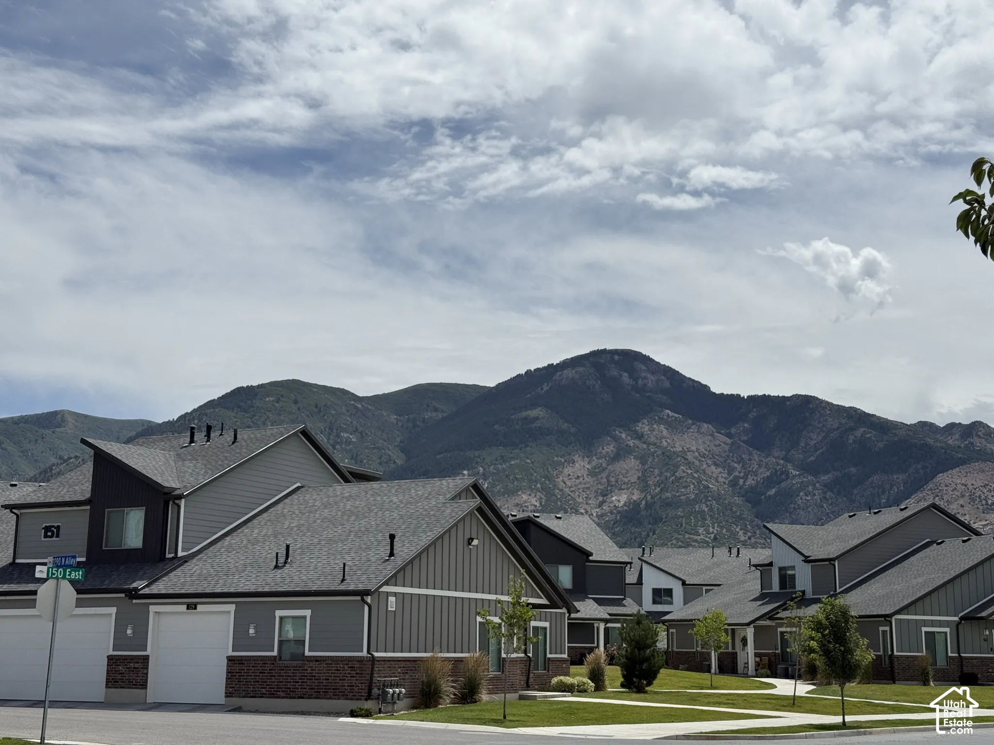 Townhome exterior featuring varied siding materials and a mountain backdrop