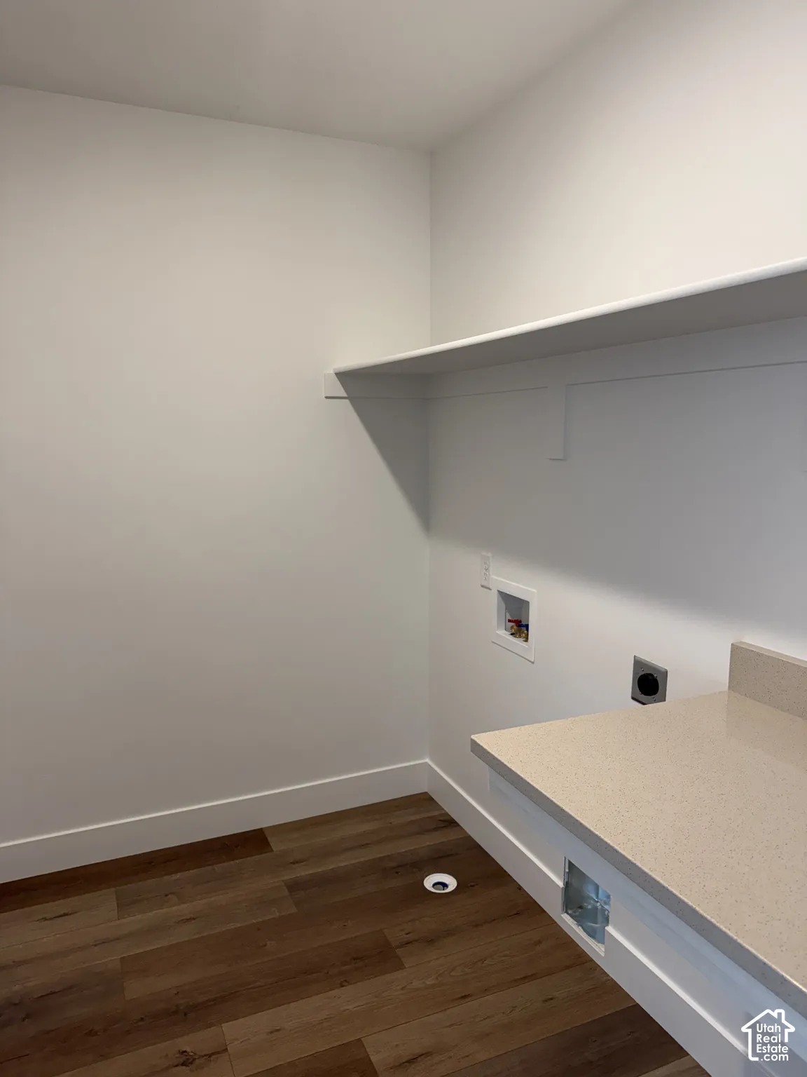 Built-in shelving, wood-finish flooring, and a stone-finish countertop