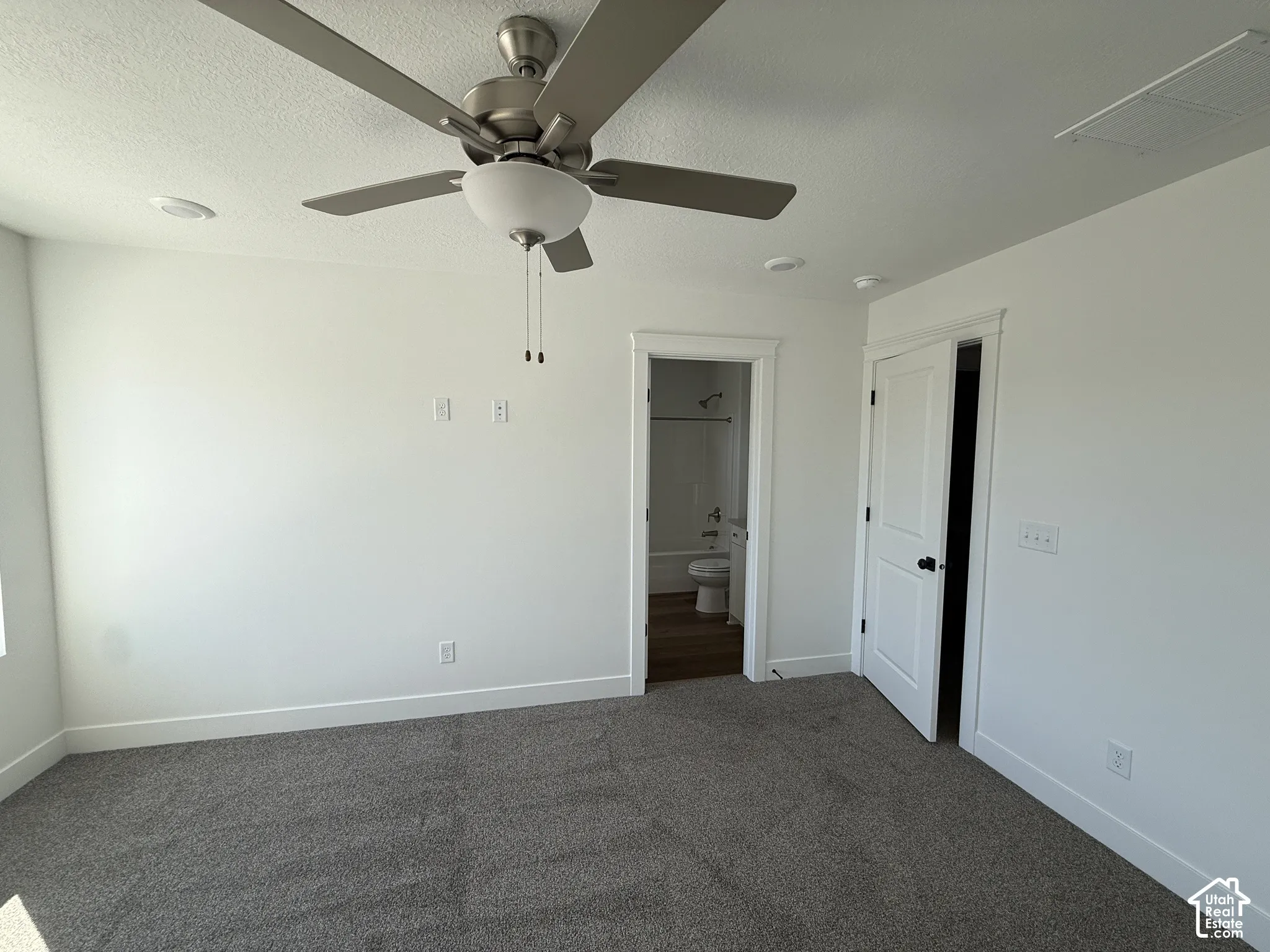 Neutral wall paint, ceiling fan with light fixture, recessed lighting, carpet flooring, and white trim