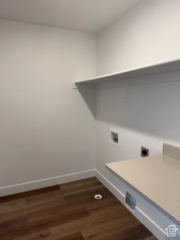 Built-in shelving, wood-finish flooring, and a stone-finish countertop