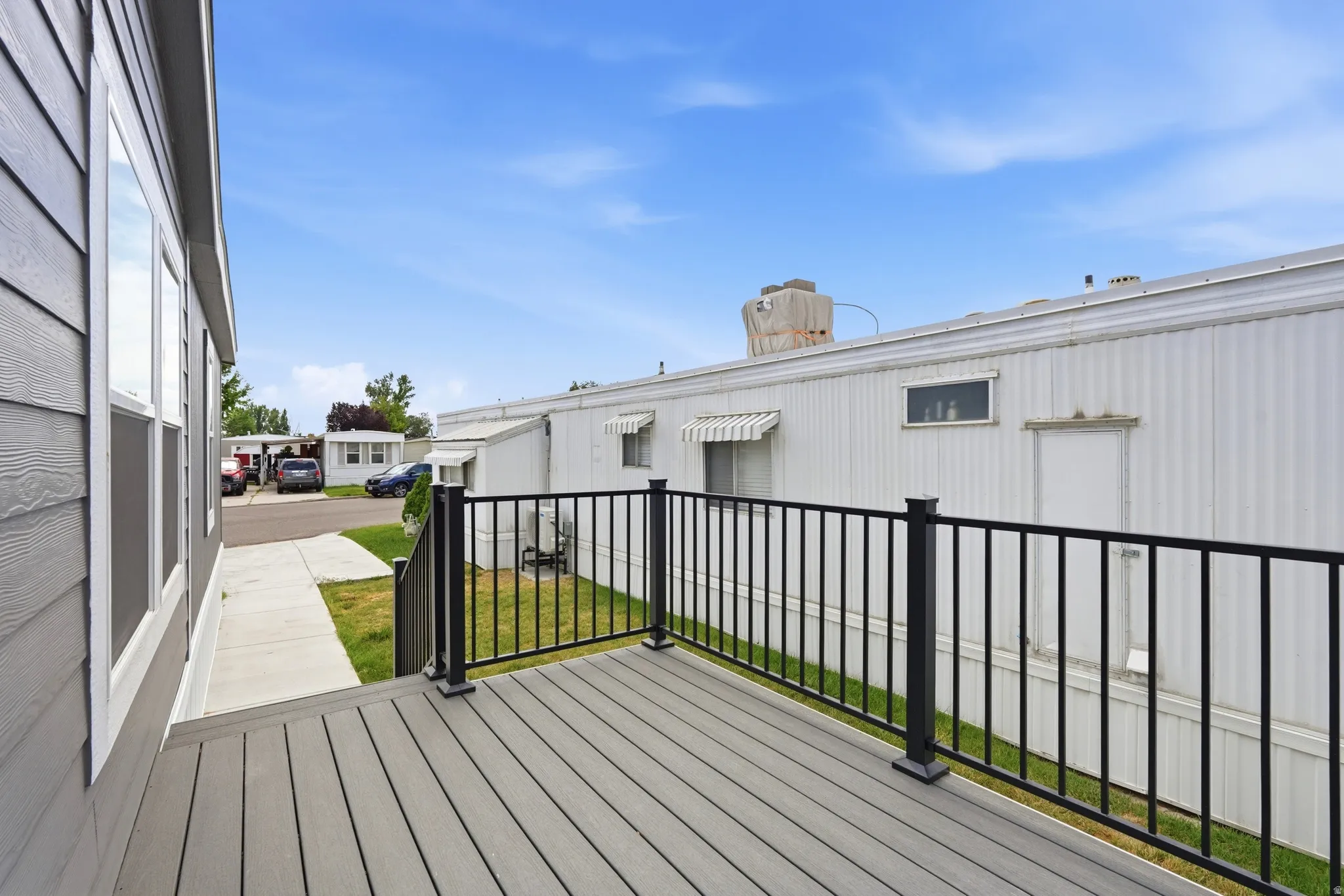 Outdoor deck featuring composite decking and black metal railings