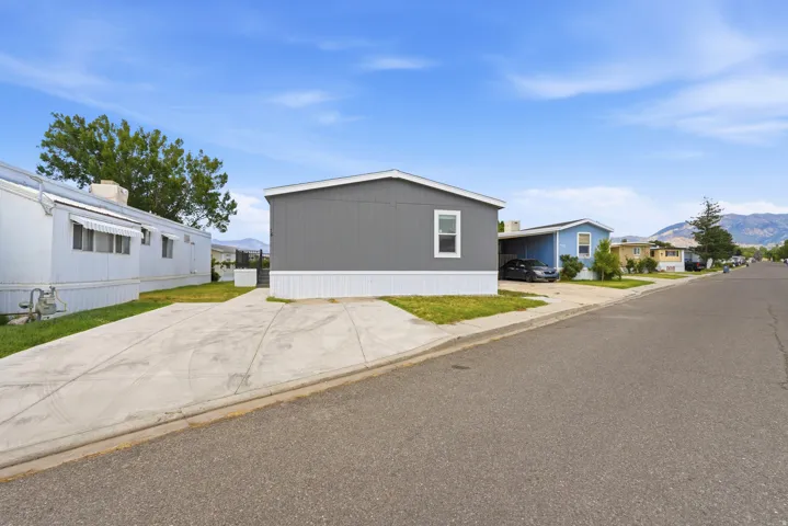 Contemporary manufactured home featuring gray horizontal siding and white trim