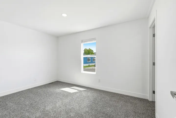 Room featuring neutral paint, gray carpeting, a single window, recessed lighting, and white baseboards