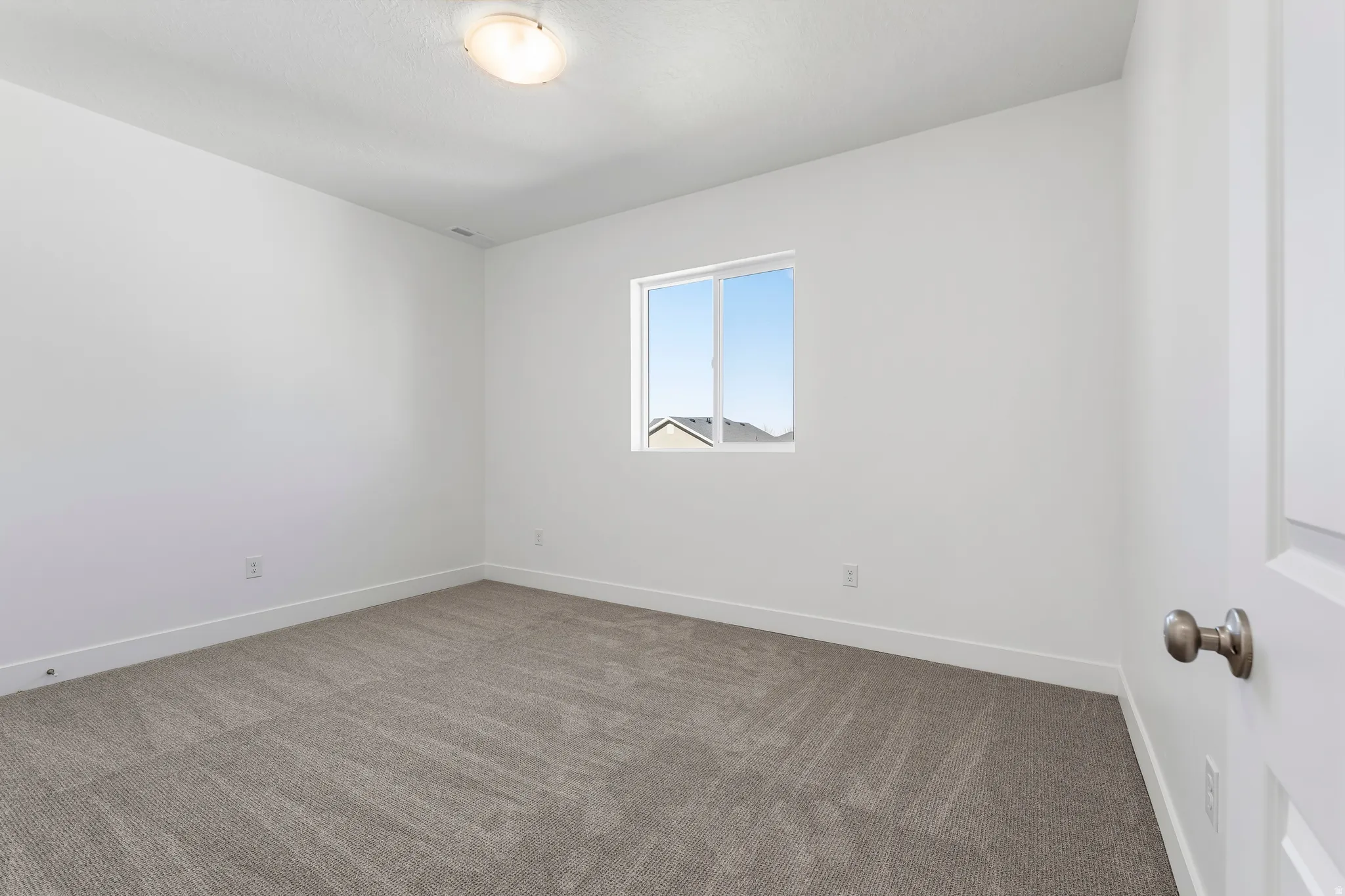 Neutral-toned carpeting complements crisp white walls