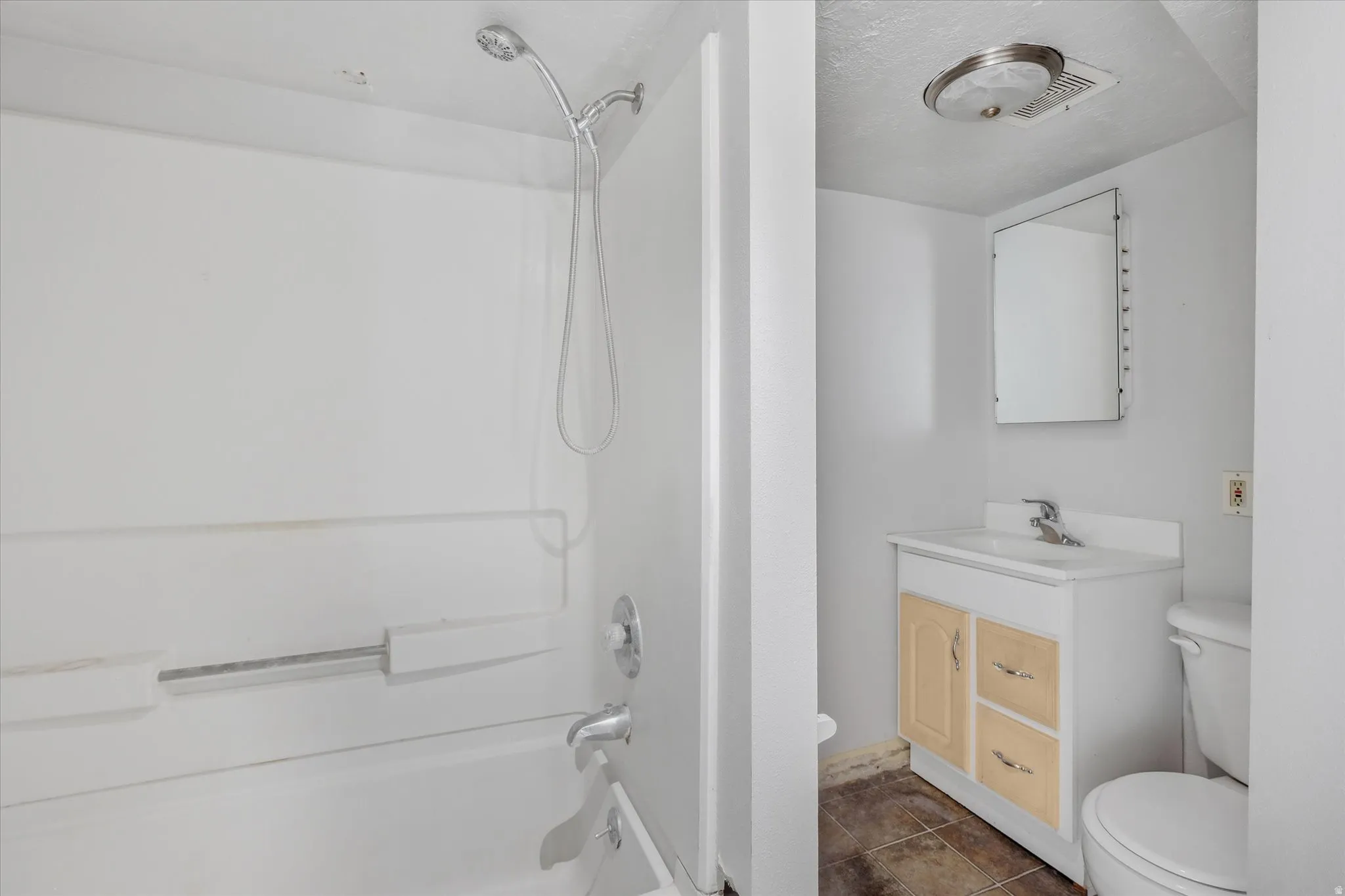 Bathroom featuring a white shower-over-tub combination with a chrome showerhead and faucet