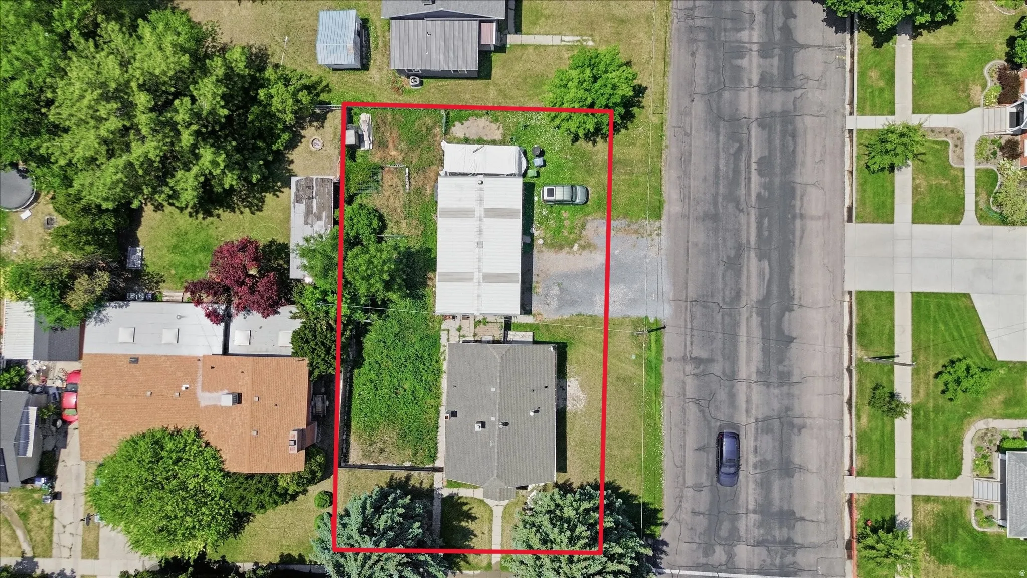 Aerial perspective showcasing the property's rectangular lot with established trees
