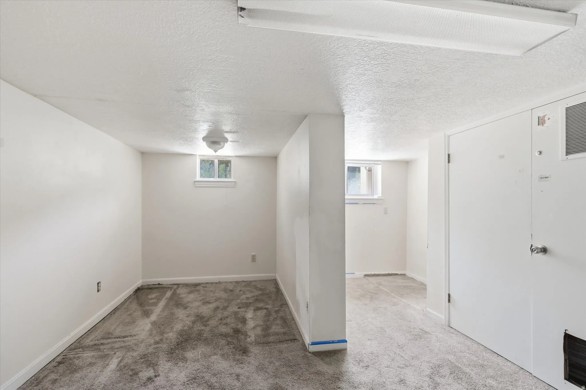 Finished interior space featuring textured ceilings and light-colored walls