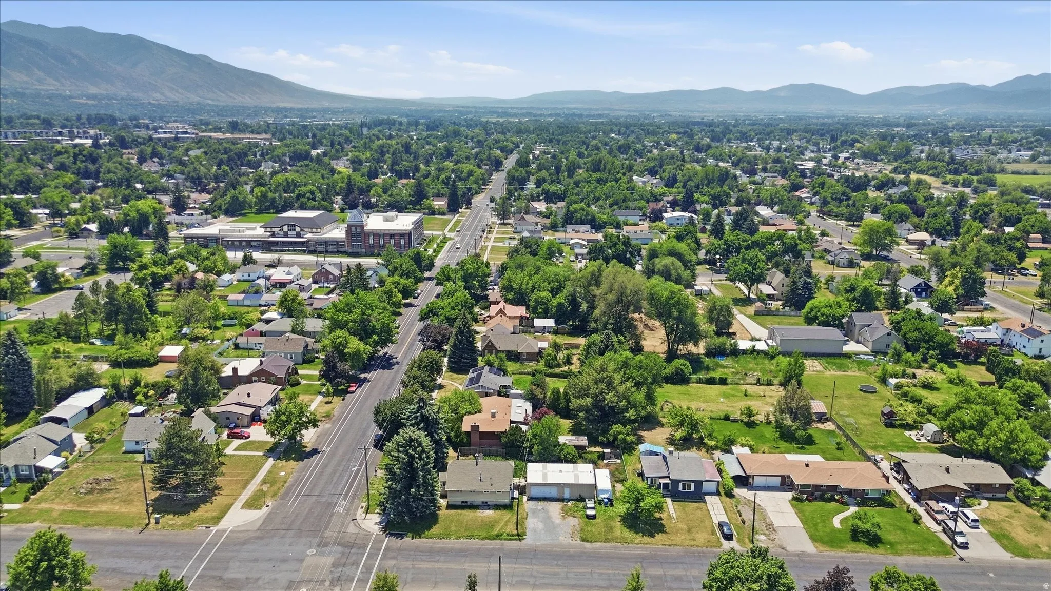 Expansive aerial view showcasing a residential area with varied housing styles and mature landscaping