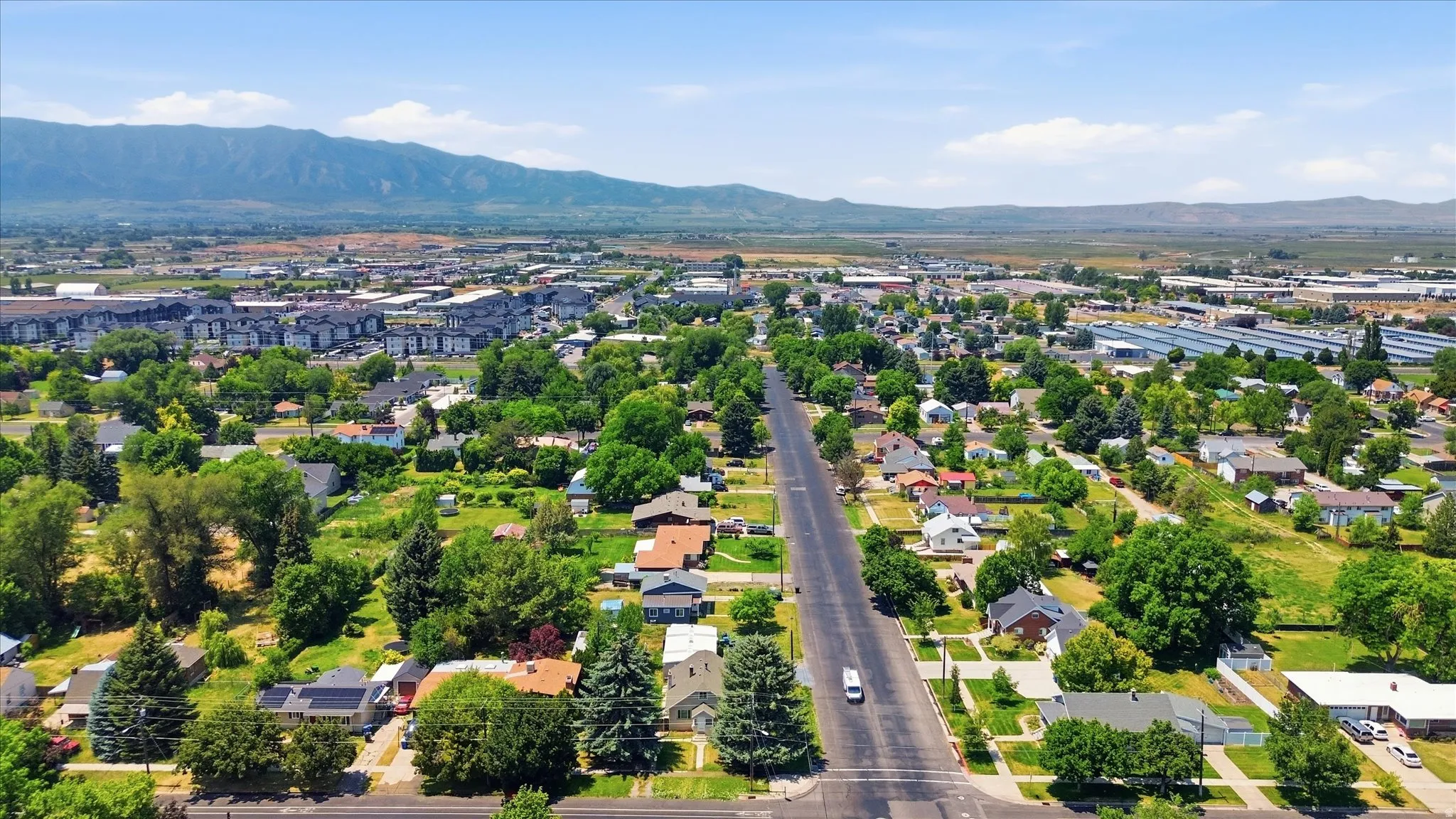 Aerial perspective showcasing a residential area with varied housing styles and mature trees