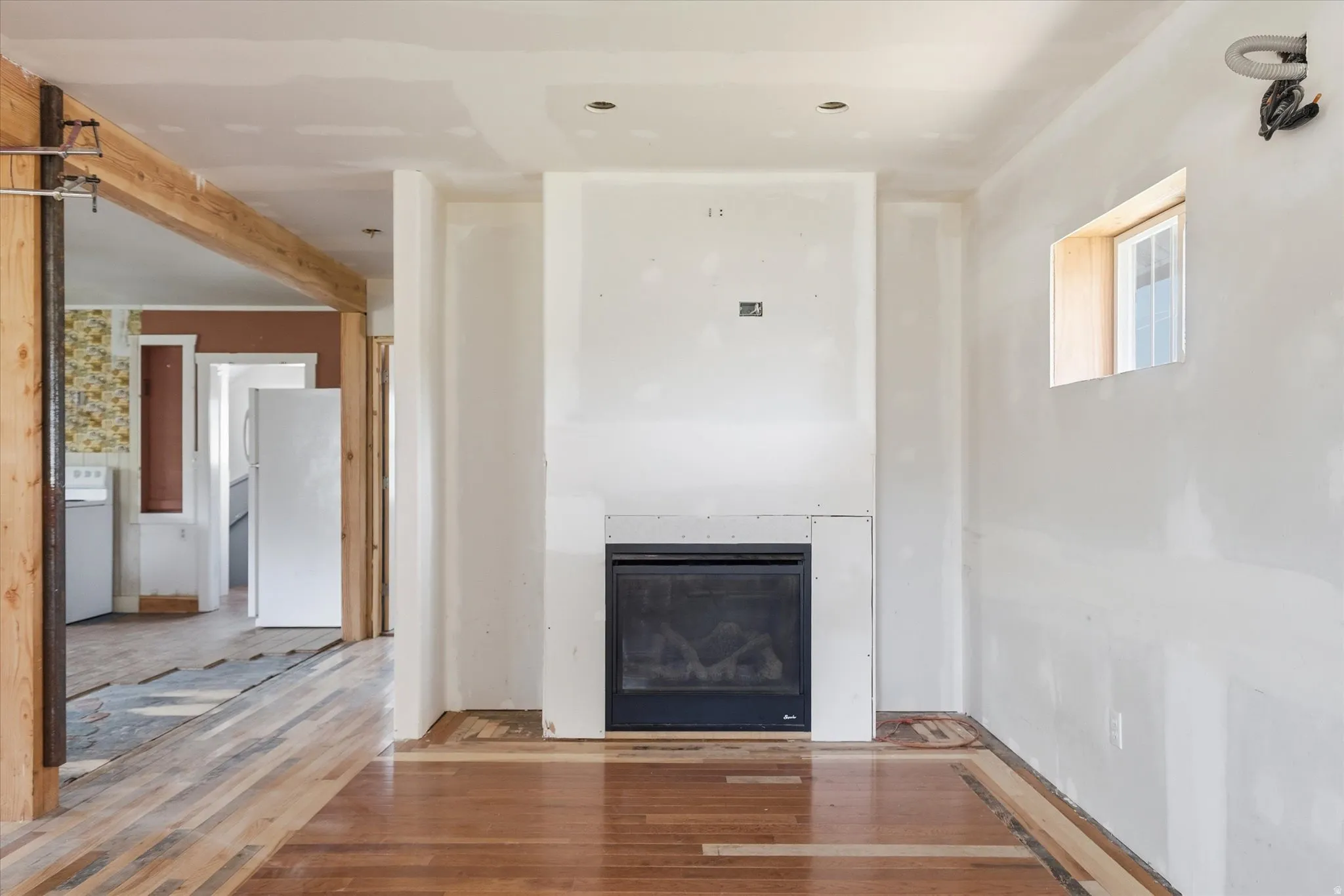 Room with partial wood-finish flooring and a built-in fireplace