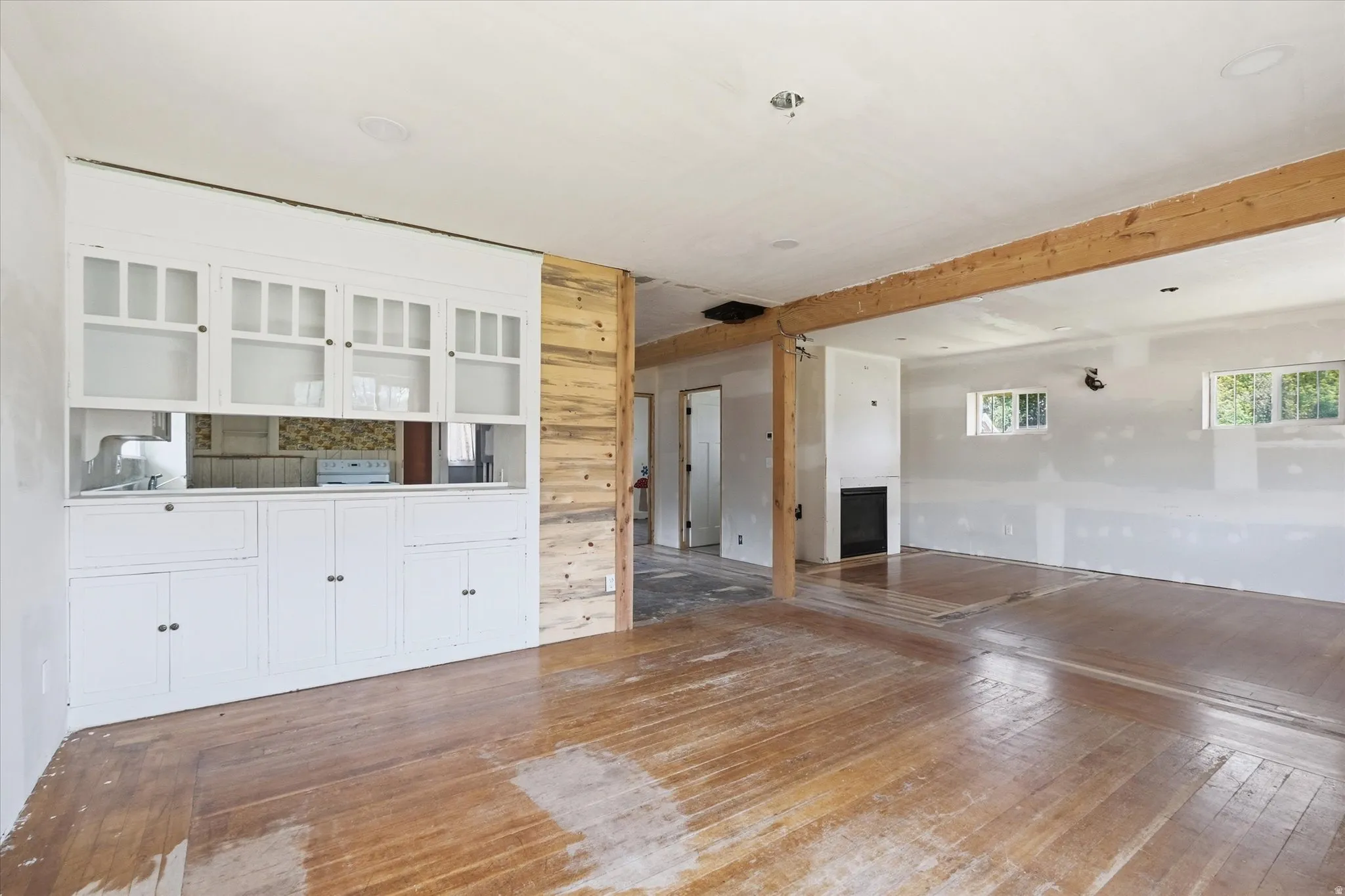 Built-in white cabinetry with glass-paneled upper doors
