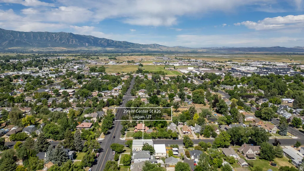 Aerial perspective showcasing a residential neighborhood with a prominent mountain range backdrop