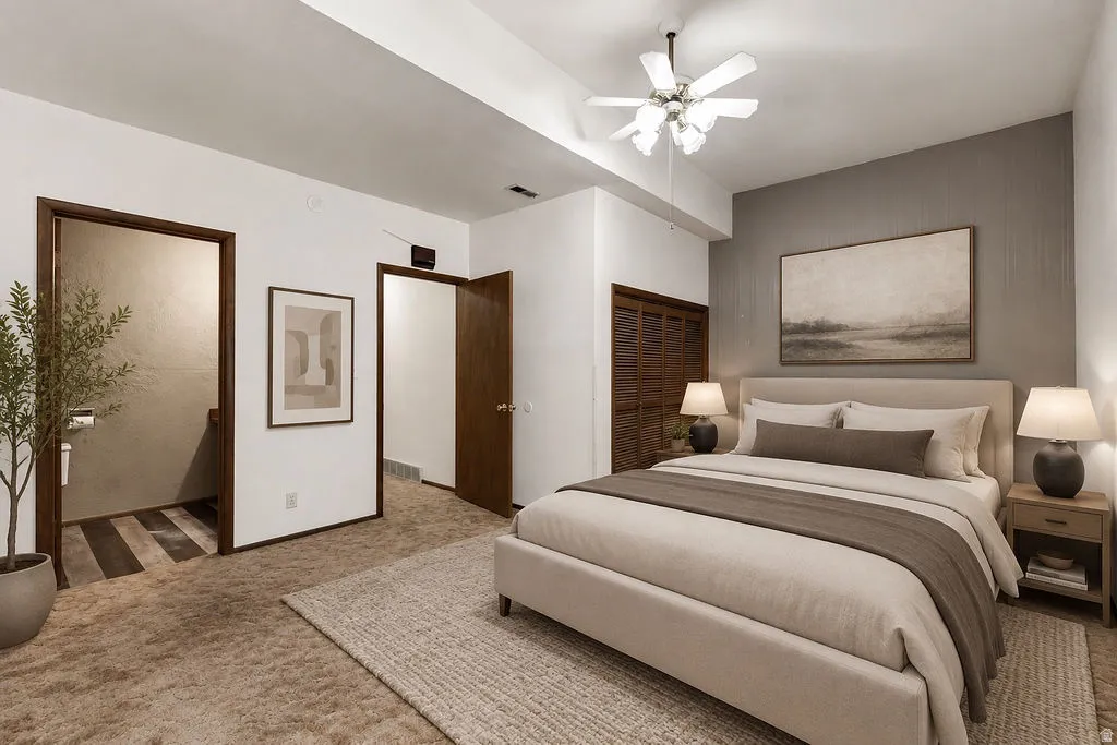 Bedroom featuring a textured accent wall, ceiling fan, and carpeted flooring