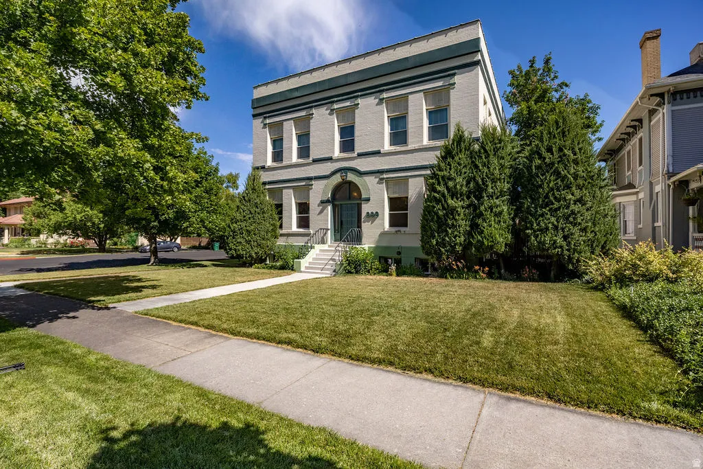 Classical-style building with a light-colored facade and dark trim details