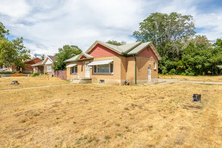 Brick exterior with a gabled roof and white awnings