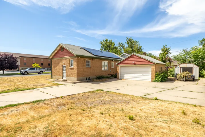 Brick exterior with a gabled roof and integrated solar panels