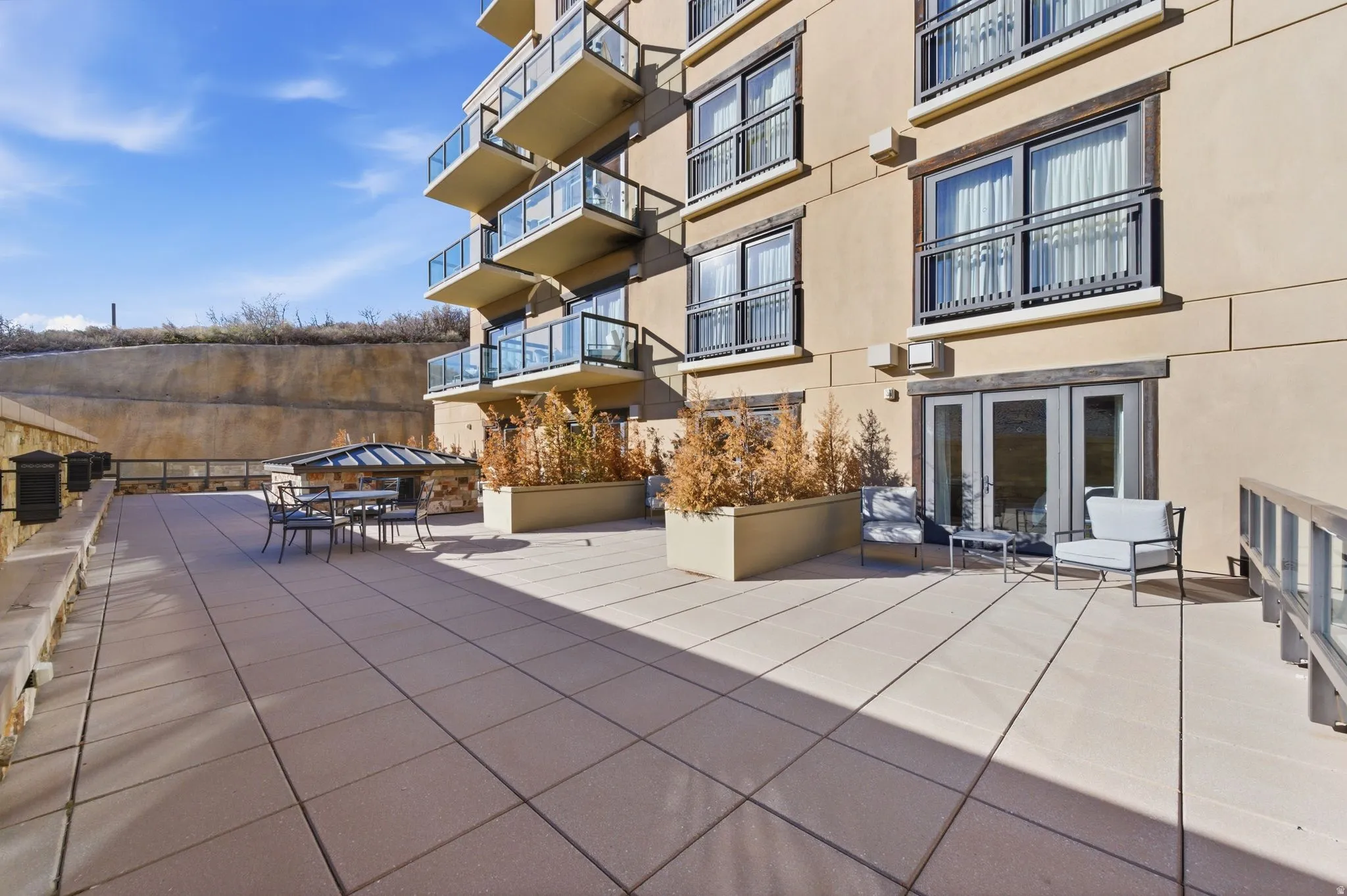 Expansive paver patio with a low-profile planter box