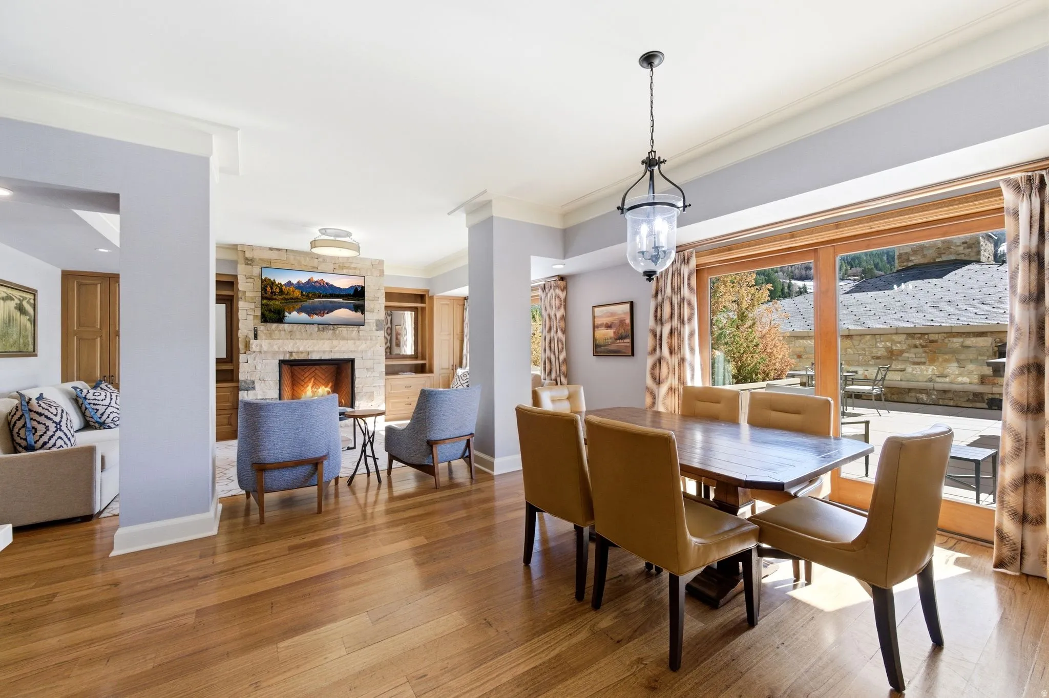 Expansive wood-finish flooring extending through the living and dining areas