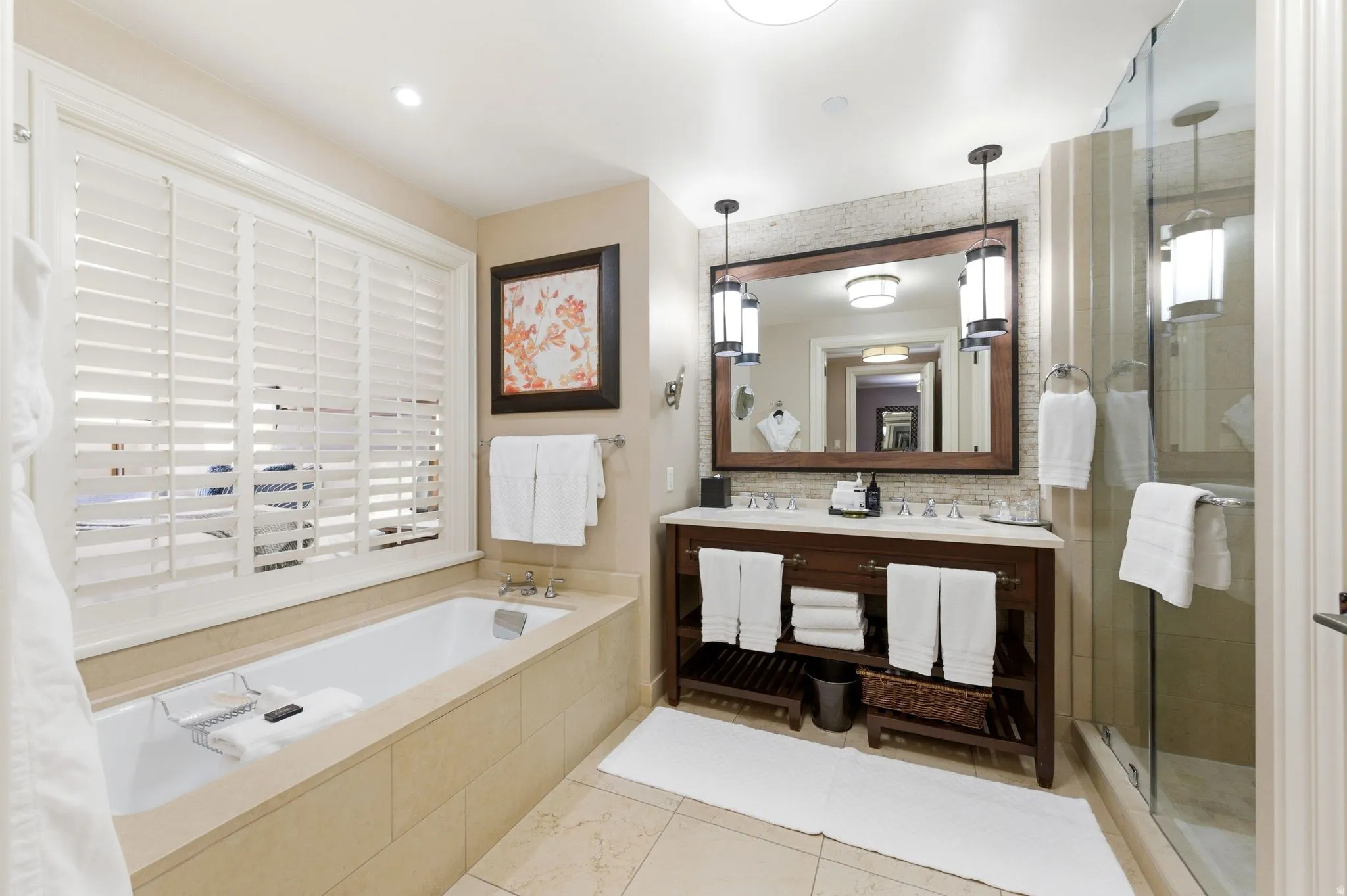 Bathroom featuring a built-in soaking tub with white plantation shutters