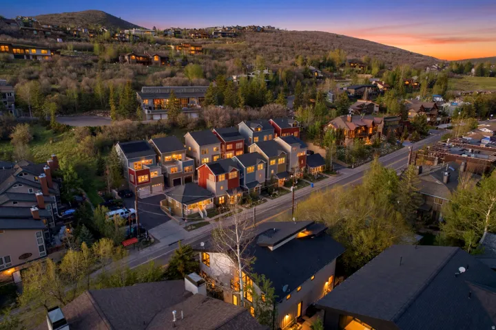 Modern townhomes featuring varied exterior finishes and attached garages