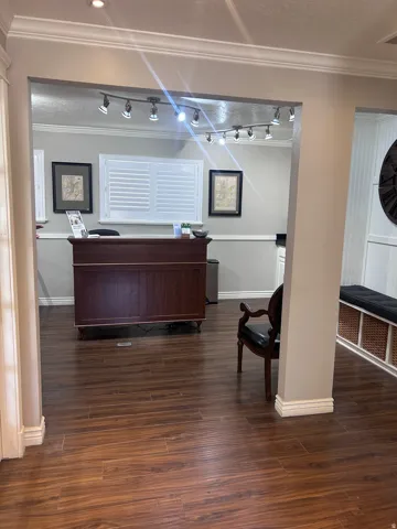 Wood-finish flooring extending through an arched entryway