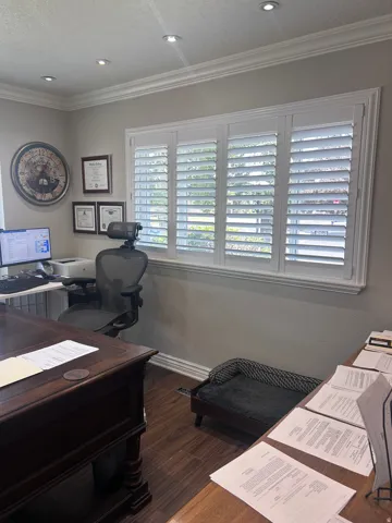 Home office featuring wood-finish flooring, white plantation shutters, crown molding, recessed lighting, and a neutral wall color
