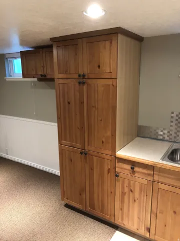 Custom cabinetry with knotty wood-finish doors and dark hardware