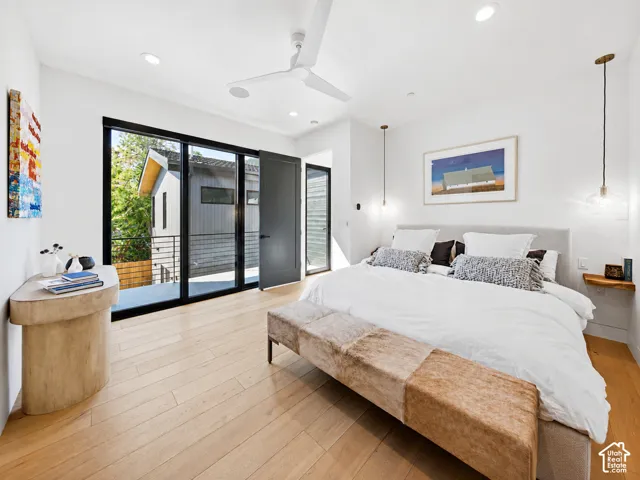 Spacious interior featuring light wood-finish flooring, recessed ceiling lighting, and a white ceiling fan