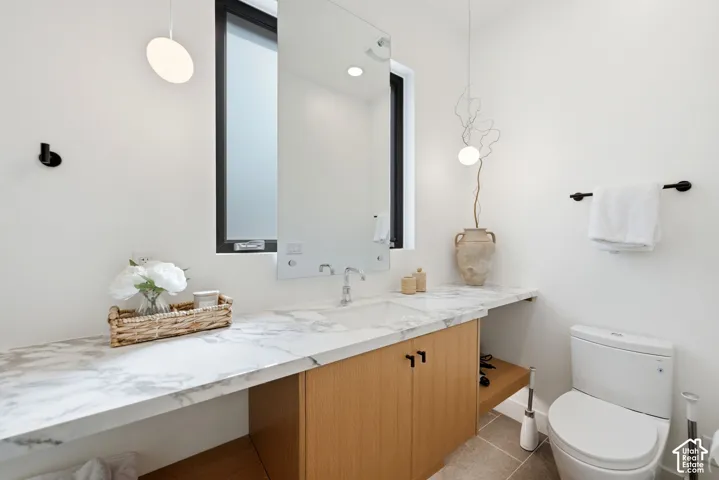 Marble-finish countertop with an integrated sink and light wood-finish cabinetry