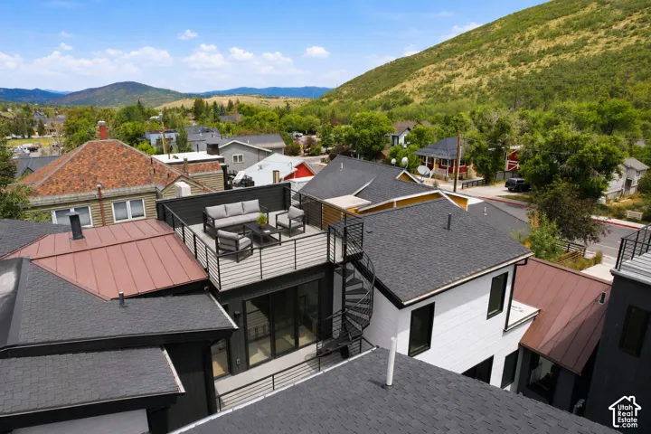 Rooftop deck featuring metal railings and a privacy fence
