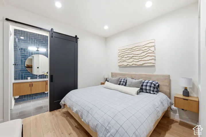 Bedroom featuring light wood-finish flooring and recessed lighting