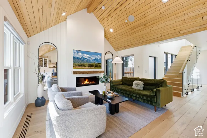 Vaulted wood-plank ceilings above light wood-finish flooring