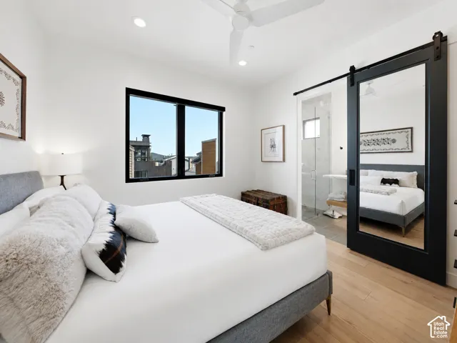 Bright room featuring a black-framed window, recessed lighting, and wood-finish flooring
