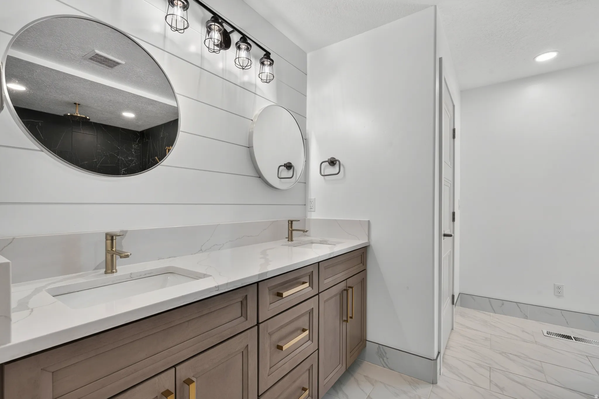 Dual vanity with integrated rectangular sinks, white countertop, and gold-toned fixtures