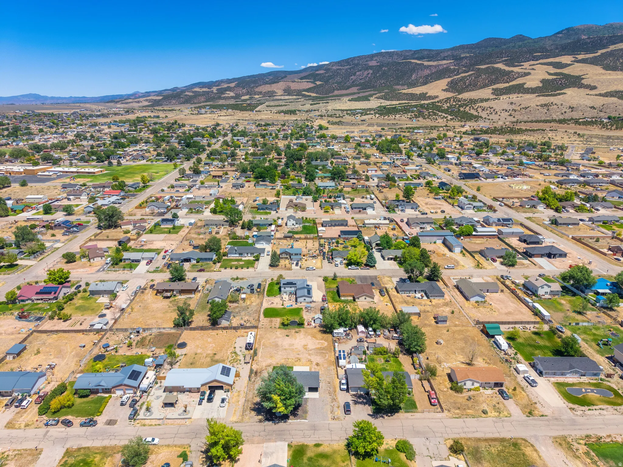 Aerial perspective showcasing a residential community with distant mountainous terrain