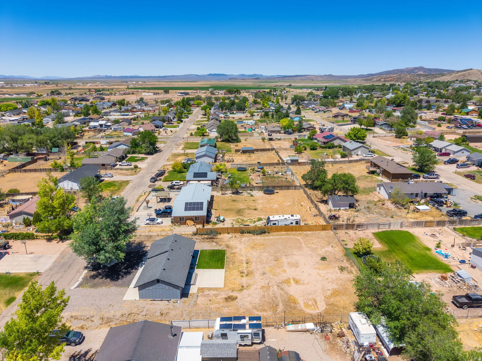 Aerial perspective of a residential neighborhood with distant mountain ranges