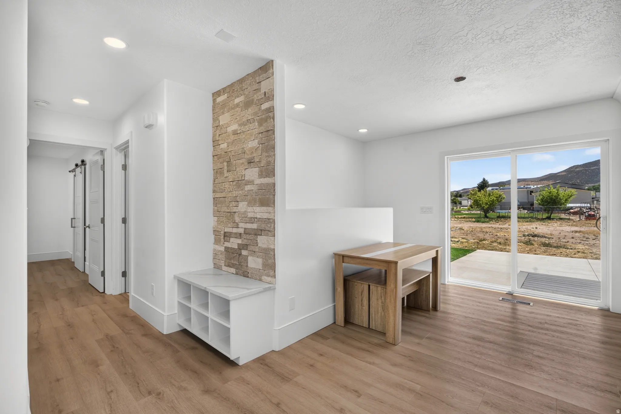 Entryway featuring wood-finish flooring and recessed lighting