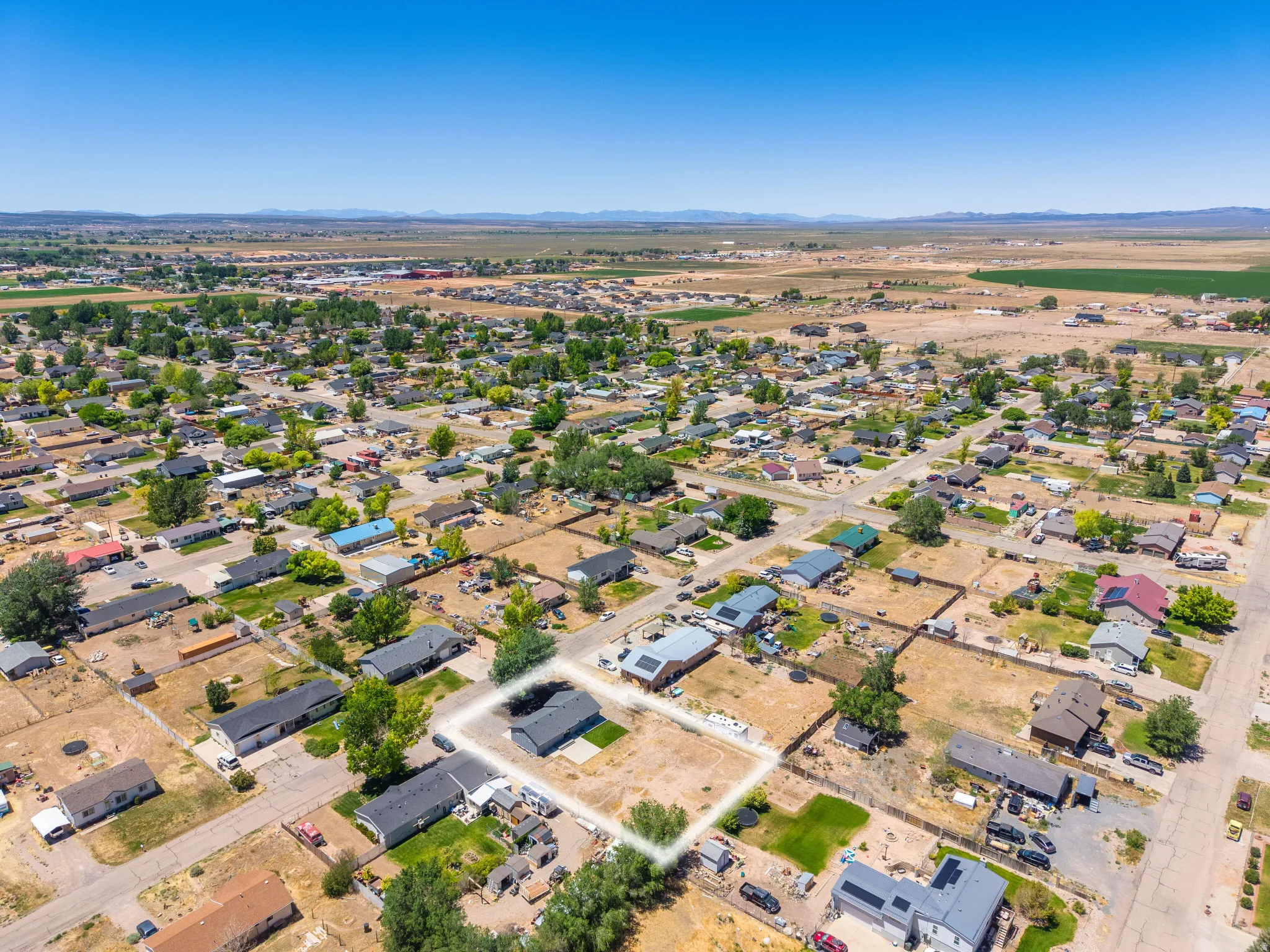 Aerial perspective showcasing a residential neighborhood with distant landscape features