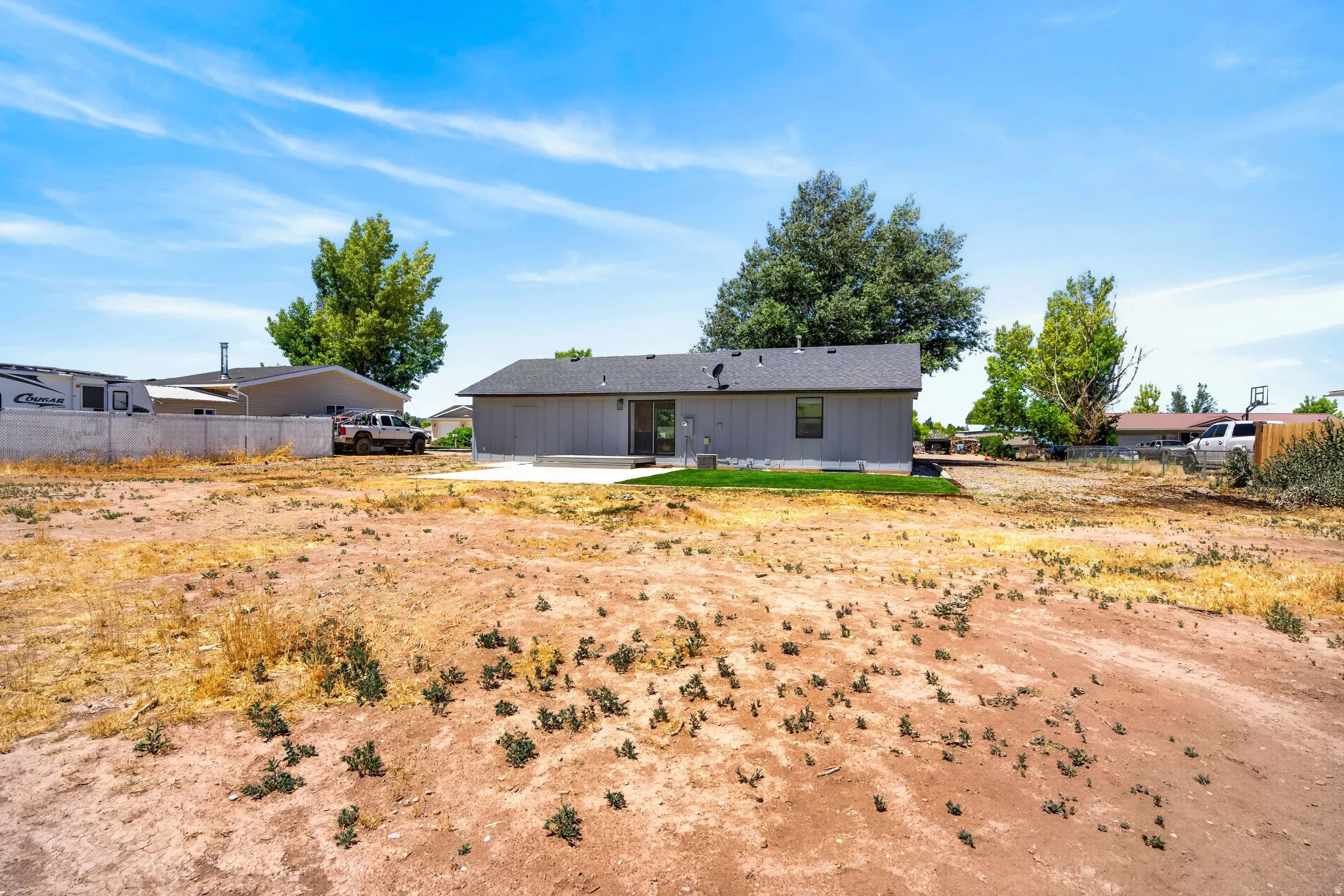 Expansive rear yard with a concrete patio
