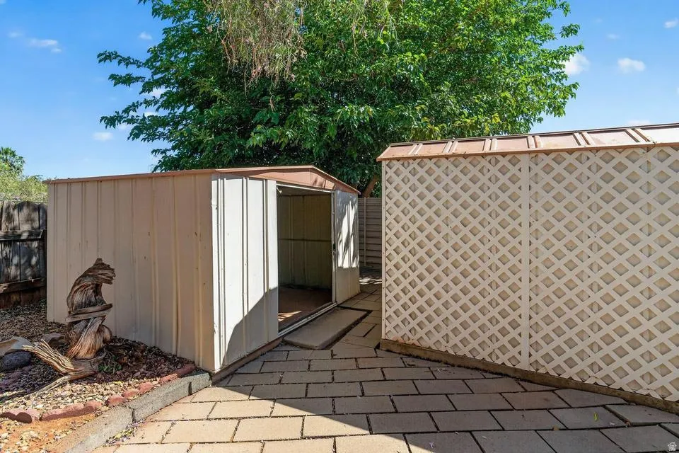 Two detached storage sheds with a paver patio