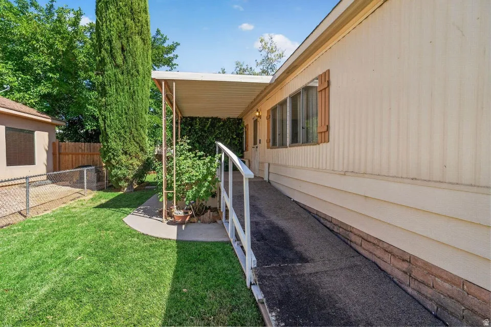 Covered entryway with a white railing and an accessible ramp