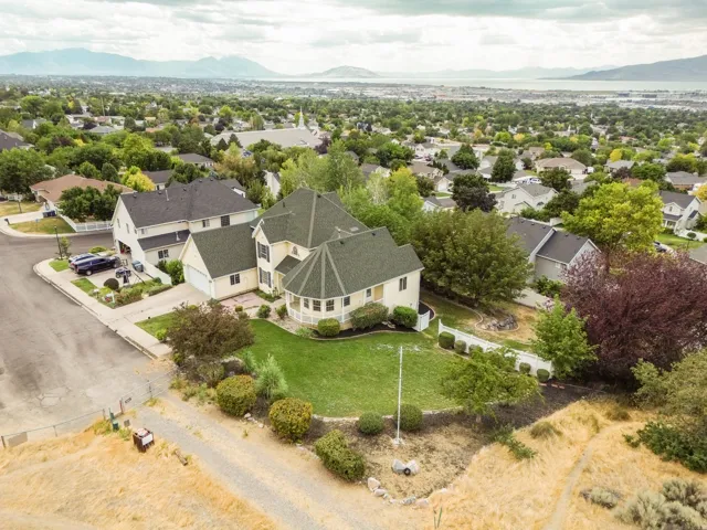 Spacious property featuring a landscaped front yard, two-story residence with a turret, and a paved driveway