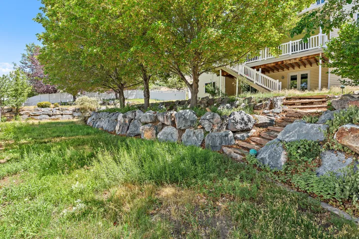 Terraced landscaping featuring rock retaining walls and stone steps