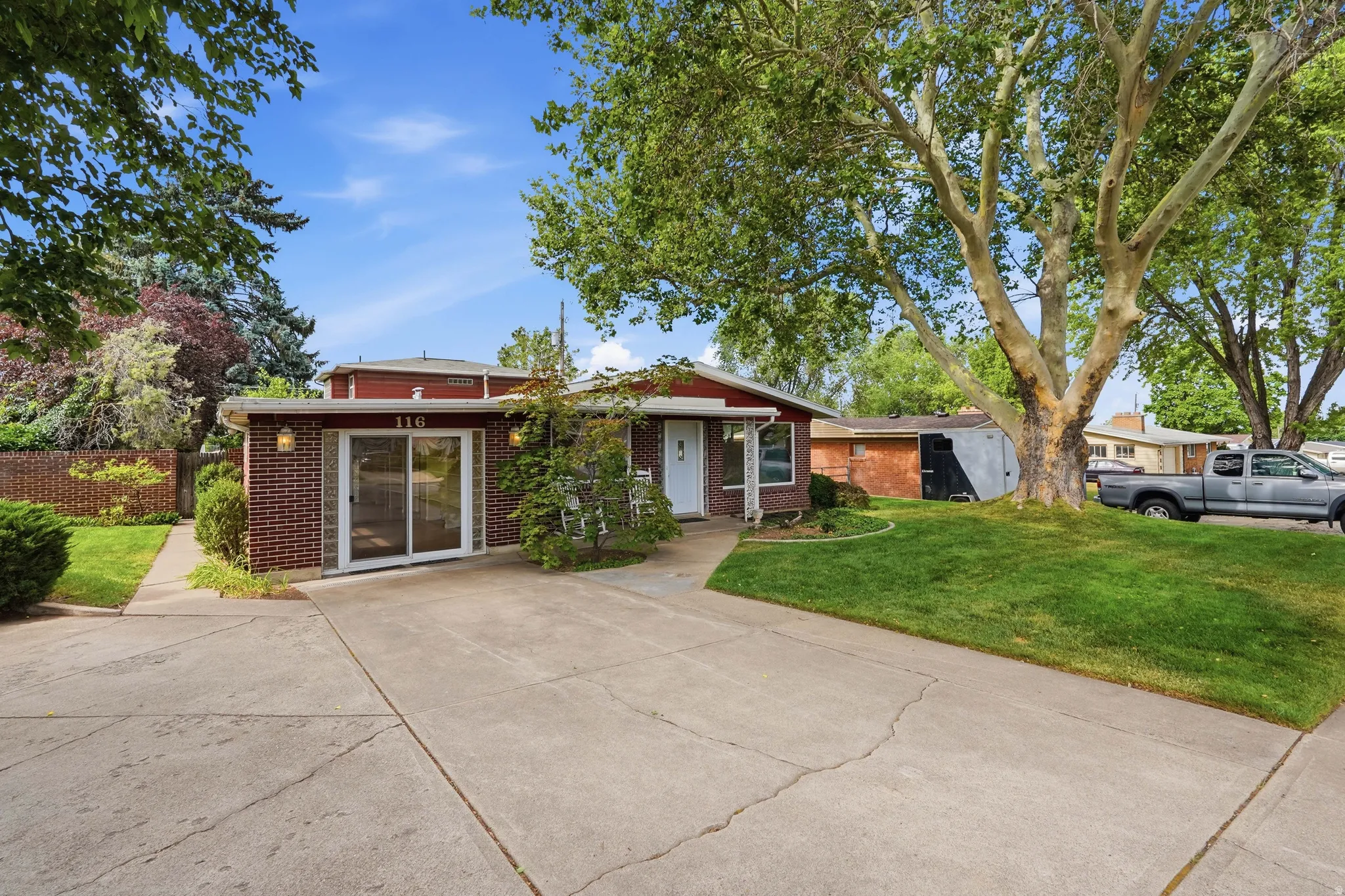 Mid-century brick facade with a wide concrete driveway